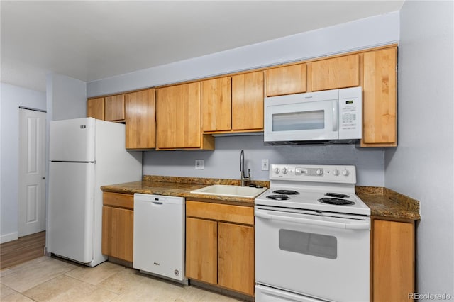 kitchen with white appliances and a sink