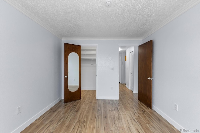 unfurnished bedroom featuring crown molding, light wood-style flooring, and baseboards