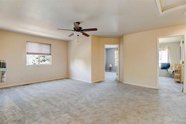 unfurnished room with light carpet and ceiling fan