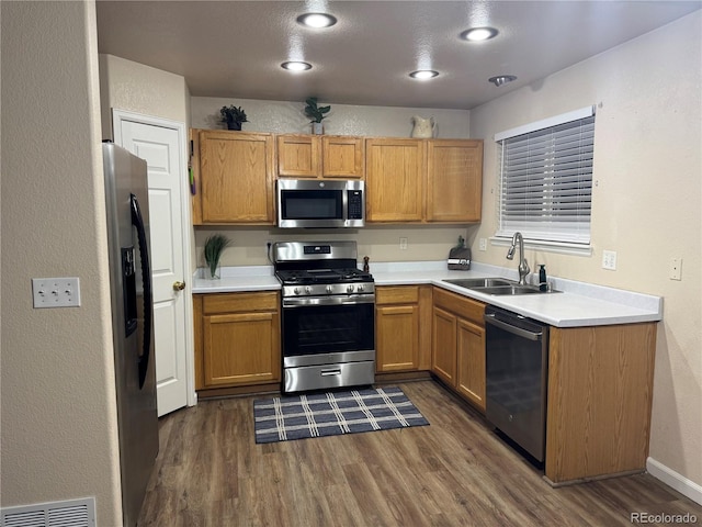 kitchen with dark hardwood / wood-style flooring, sink, and appliances with stainless steel finishes