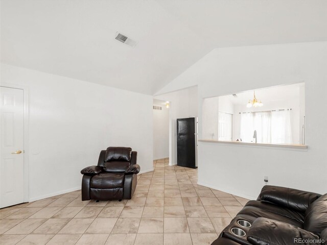 1748 Eagle St Unit B, Aurora, CO 80011 - sitting room with lofted ceiling, a chandelier, visible vents, and light tile patterned floors