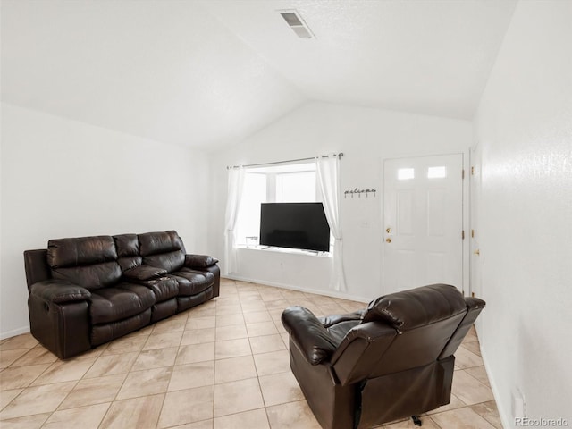 1748 Eagle St Unit B, Aurora, CO 80011 - living room with light tile patterned floors, visible vents, baseboards, and lofted ceiling