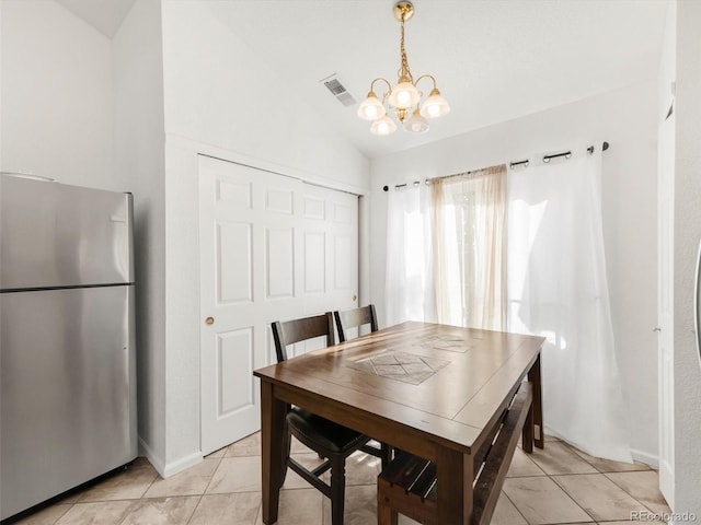 1748 Eagle St Unit B, Aurora, CO 80011 - dining room with light tile patterned floors, a chandelier, visible vents, baseboards, and vaulted ceiling