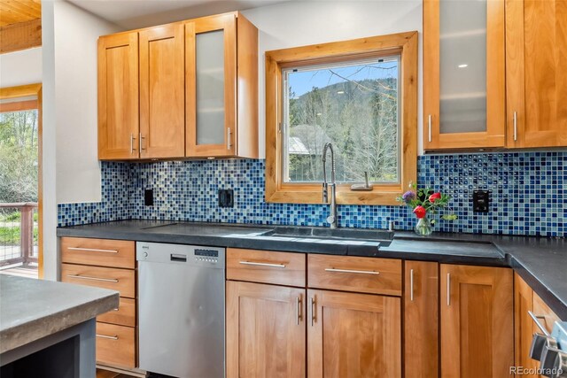 475 Vail Cir, Dillon, CO 80435 - kitchen with stainless steel dishwasher, a sink, dark countertops, and tasteful backsplash