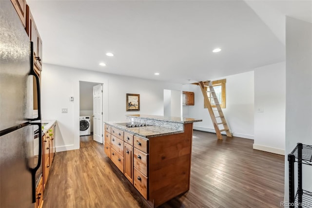 475 Vail Cir, Dillon, CO 80435 - kitchen with freestanding refrigerator, washer / clothes dryer, brown cabinets, dark wood-style flooring, and recessed lighting