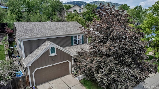 573 Entrada Dr, Golden, CO 80401 - view of front facade with a shingled roof, board and batten siding, and a garage