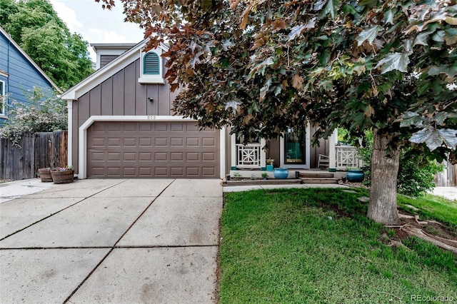 573 Entrada Dr, Golden, CO 80401 - obstructed view of property with board and batten siding, driveway, and a garage