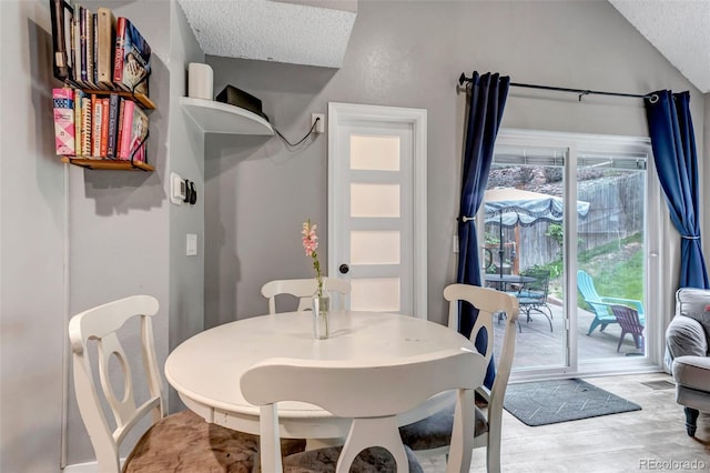 573 Entrada Dr, Golden, CO 80401 - dining area with lofted ceiling, a textured ceiling, and light wood finished floors
