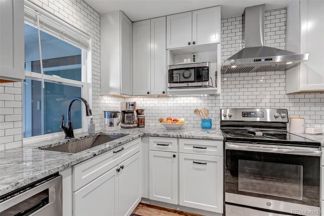 573 Entrada Dr, Golden, CO 80401 - kitchen with appliances with stainless steel finishes, wall chimney exhaust hood, a sink, and backsplash