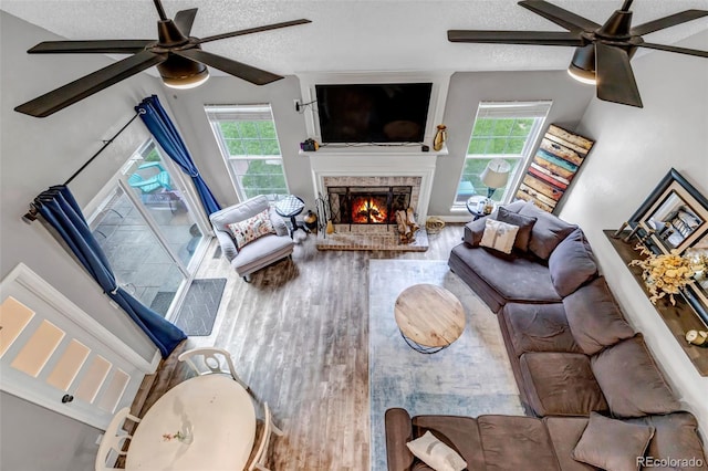 573 Entrada Dr, Golden, CO 80401 - living room featuring ceiling fan, healthy amount of natural light, wood finished floors, and a textured ceiling