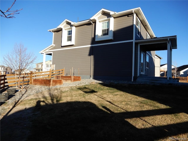 rear view of house featuring a yard