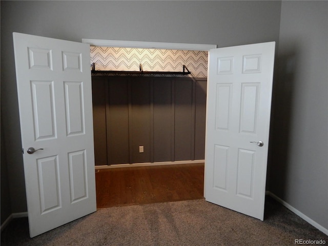 unfurnished bedroom with dark colored carpet