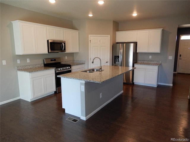 kitchen featuring white cabinets, appliances with stainless steel finishes, and sink