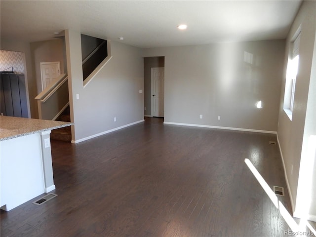 unfurnished living room with dark hardwood / wood-style floors