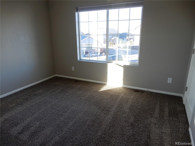 empty room featuring dark carpet