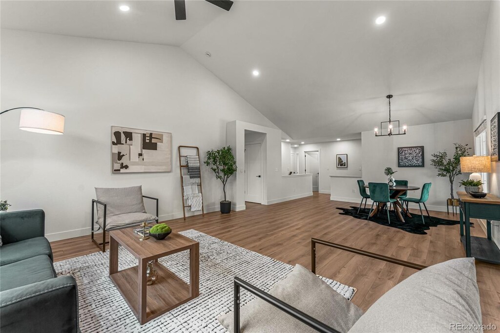4043 E Geddes Cir, Centennial, CO 80122 - living room featuring baseboards, recessed lighting, wood finished floors, and ceiling fan with notable chandelier