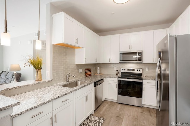 15700 E Jamison Dr Unit 8-103, Englewood, CO 80112 - kitchen with appliances with stainless steel finishes, light stone countertops, tasteful backsplash, and white cabinetry
