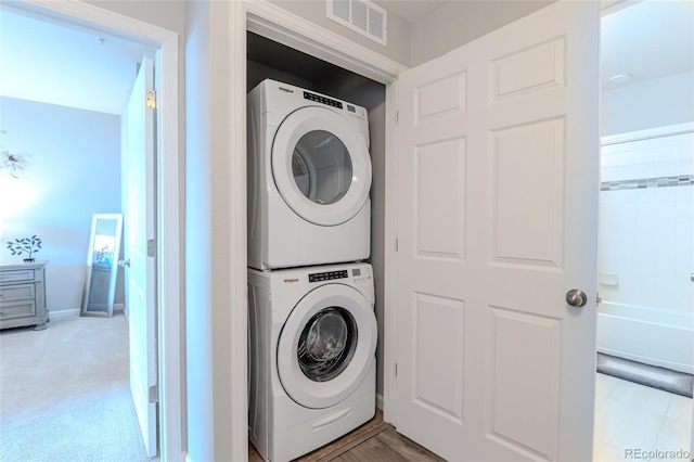 laundry area with stacked washer and dryer