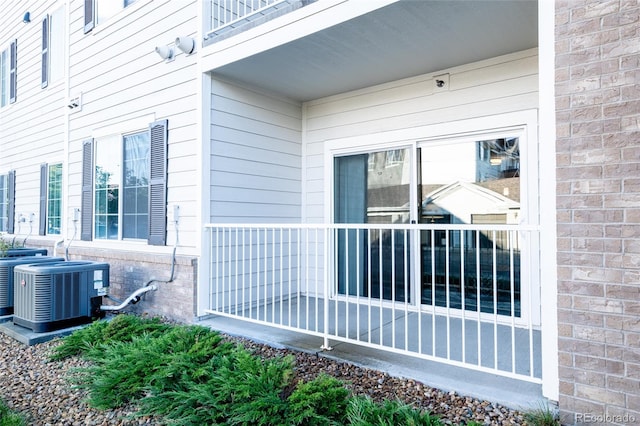 entrance to property featuring a balcony and central AC unit