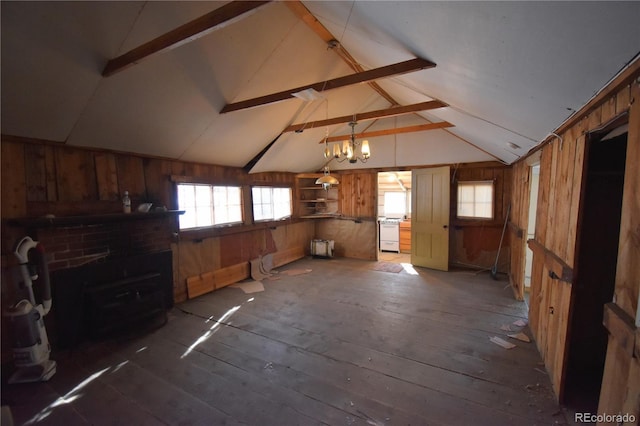 interior space featuring lofted ceiling with beams, wood walls, dark hardwood / wood-style flooring, and a wood stove