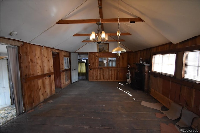 interior space with a chandelier, vaulted ceiling with beams, dark hardwood / wood-style floors, and wood walls