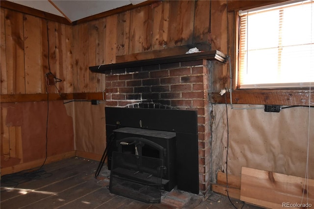 detailed view of a wood stove, wood walls, and wood finished floors