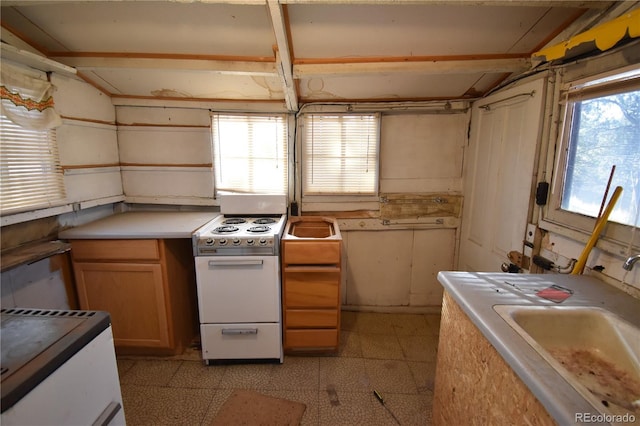 kitchen featuring white range oven and sink