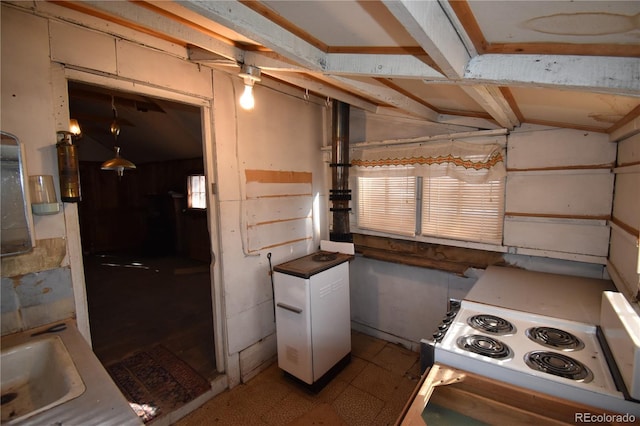 kitchen with pendant lighting, white appliances, lofted ceiling, and sink