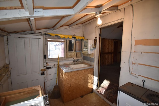 basement with ceiling fan and sink