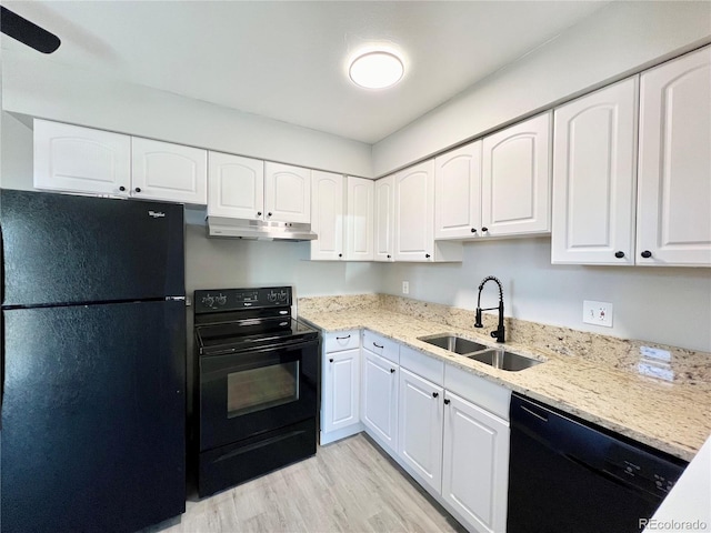 kitchen featuring light wood-type flooring, white cabinets, sink, and black appliances