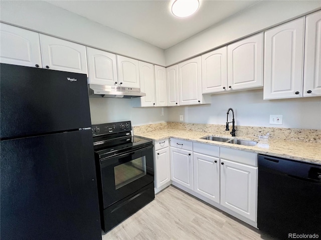 kitchen featuring sink, light stone counters, black appliances, light hardwood / wood-style floors, and white cabinets