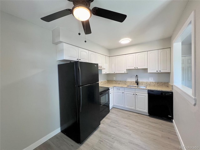 kitchen featuring sink, black appliances, white cabinets, and light wood-type flooring