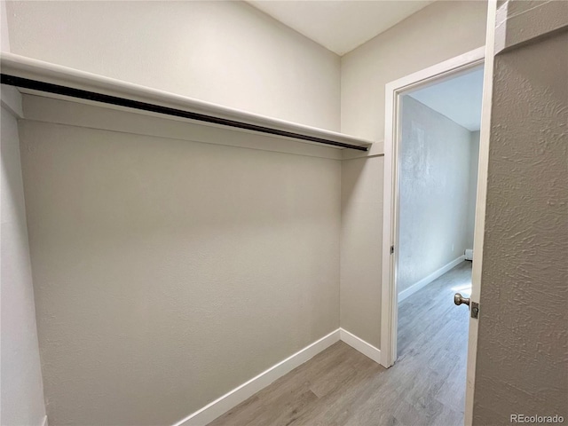 walk in closet featuring light hardwood / wood-style floors