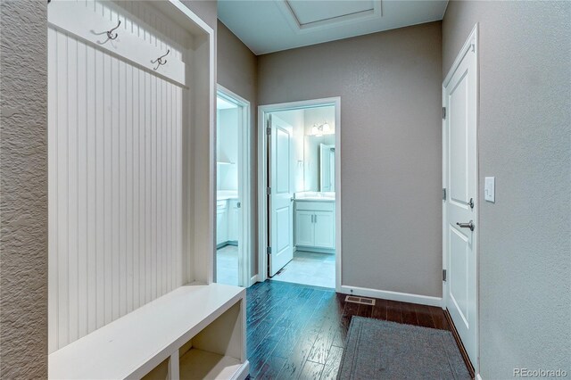 15619 Syracuse Way, Thornton, CO 80602 - mudroom with dark wood-style floors and a textured wall
