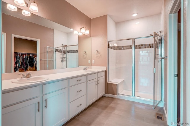 15619 Syracuse Way, Thornton, CO 80602 - full bathroom featuring a shower stall, a spacious closet, and double vanity