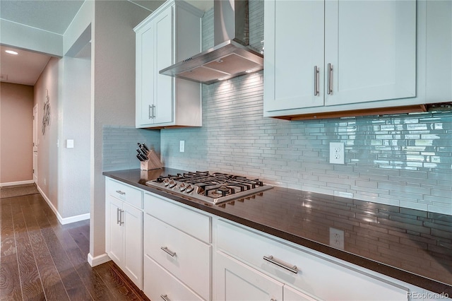 15619 Syracuse Way, Thornton, CO 80602 - kitchen with wall chimney exhaust hood, stainless steel gas stovetop, dark countertops, dark wood finished floors, and tasteful backsplash