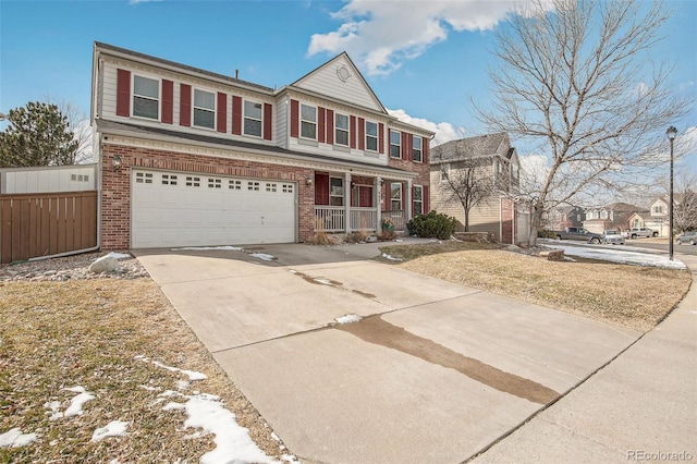 traditional-style home with driveway, a garage, covered porch, fence, and brick siding