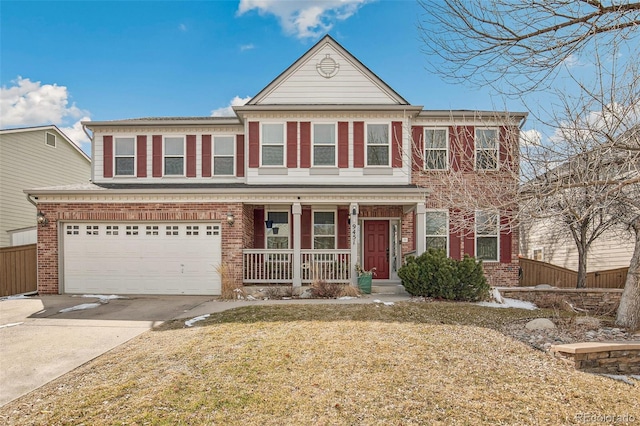 view of front of house featuring concrete driveway, an attached garage, fence, a porch, and brick siding