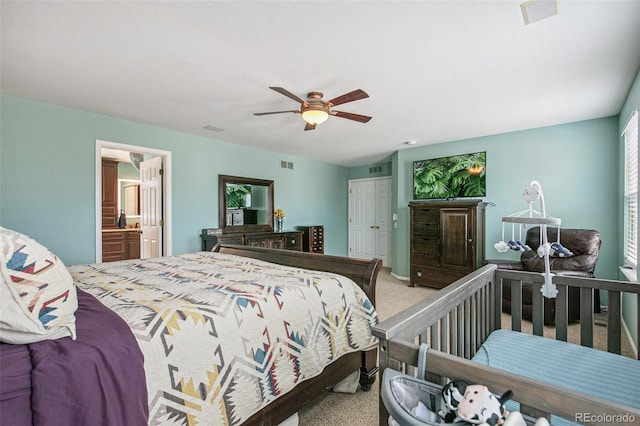 bedroom featuring carpet, visible vents, a ceiling fan, and ensuite bathroom