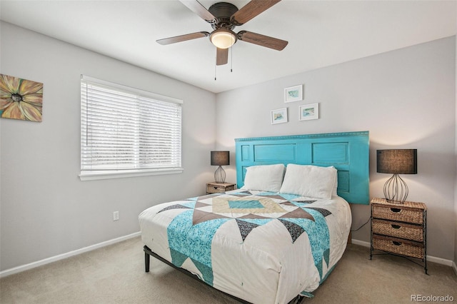 bedroom featuring light carpet, ceiling fan, and baseboards