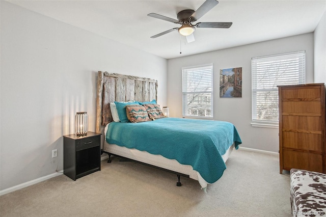 bedroom with light carpet, baseboards, and a ceiling fan