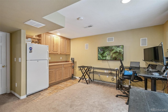 home office featuring light carpet, visible vents, and baseboards