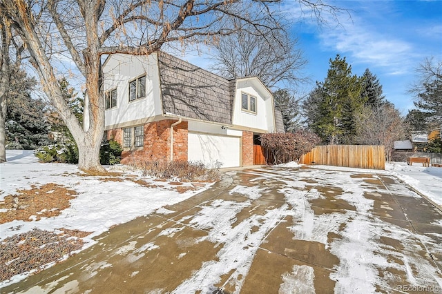 view of snowy exterior with a garage