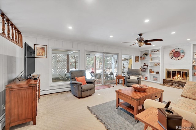 carpeted living room with crown molding, built in features, baseboard heating, and a fireplace