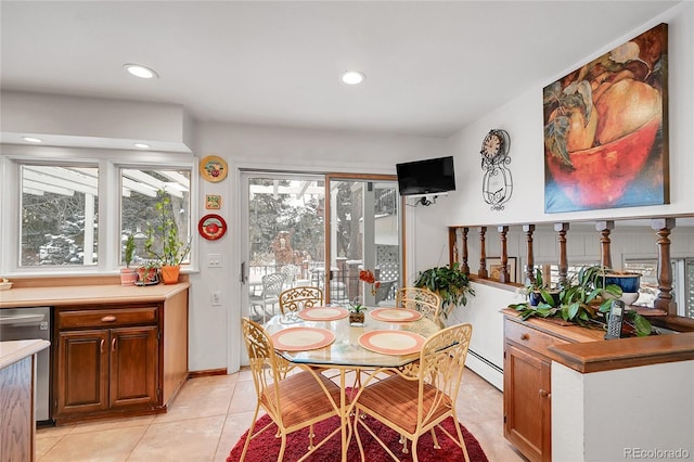 tiled dining space featuring baseboard heating