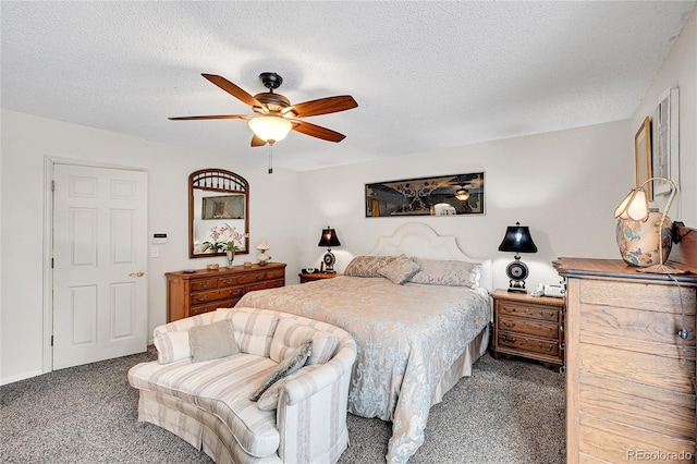 bedroom featuring dark carpet, a textured ceiling, and ceiling fan