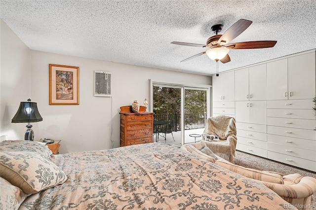 bedroom with ceiling fan, access to exterior, and a textured ceiling