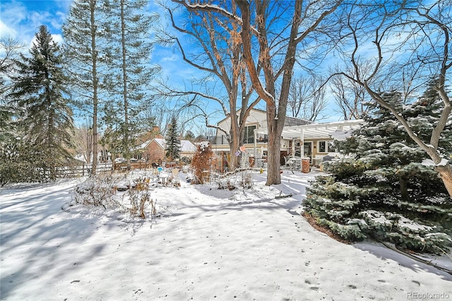 snowy yard featuring a pergola