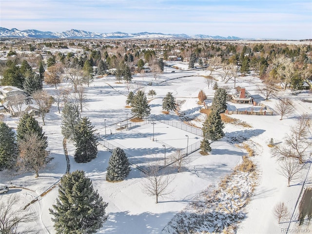 snowy aerial view with a mountain view