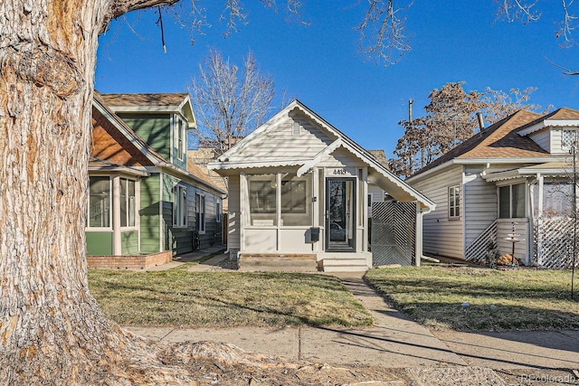 bungalow-style home with a front lawn